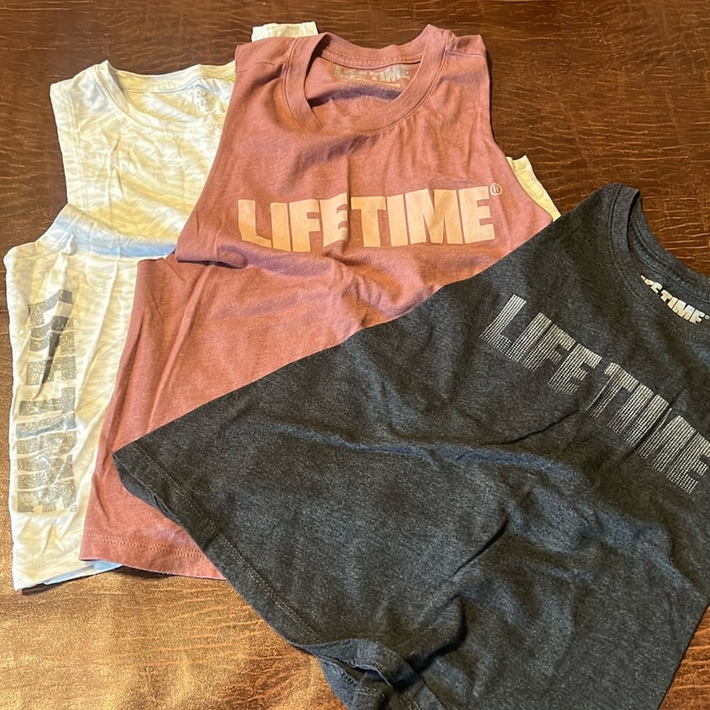 Set of three LifeTime brand crop tops in pink, dark, gray and white zebra print